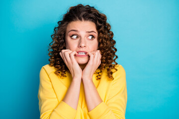 Close-up portrait of her she nice attractive afraid worried guilty wavy-haired girl waiting expecting bad news looking aside biting nails isolated over bright vivid shine vibrant blue color background