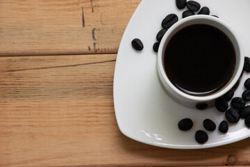 Espresso in a white cup and roasted coffee beans