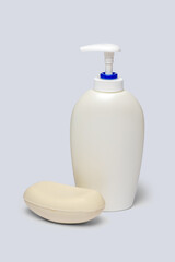 Fototapeta na wymiar piece of soap and bottle of liquid soap over light grey backgound with clipping path