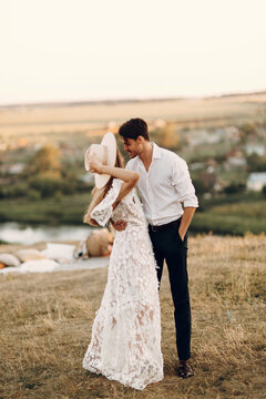 Beautiful wedding couple in nature in boho style. Wedding in the European style of fineart at sunset.