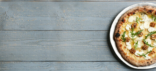 Top view of hot delicious pizza on wooden table, space for text. Banner design