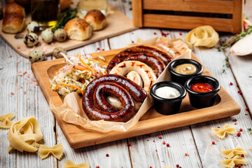 Grilled sausages with sauerkraut and sauces