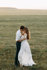 Beautiful couple in nature in boho style. Wedding in European style fine art at sunset.