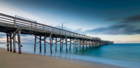 Long exposure shot of a pier on the beach in California © Rolf Nachbar/Wirestock
