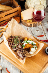 Cowboy beef steak with baked potato and sour cream
