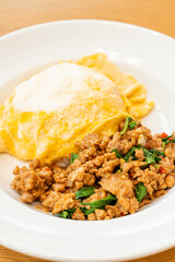 stir-fried pork and basil with creamy omelet on rice