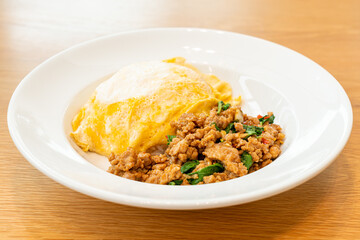 stir-fried pork and basil with creamy omelet on rice