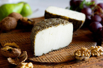 Premium organic goat cheese  on a rustic wooden cheese maker.