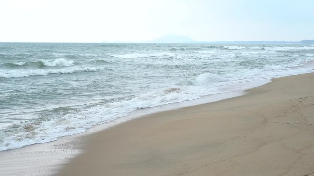 Beautiful beach with ocean waves in the morning time Thailand