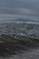 Fototapeta na wymiar Small waves breaking off the coast of New Zealand. 