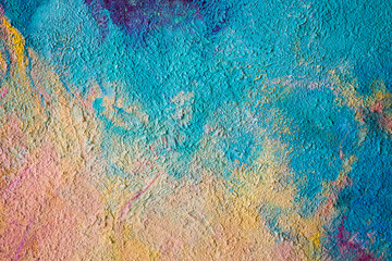 Multicolor painted wall. Bright colors on canvas. Multicolored concrete wallpaper on background