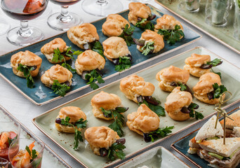 Delicious appetizers in glass cups on banquet table. Catering food, canape and snacks