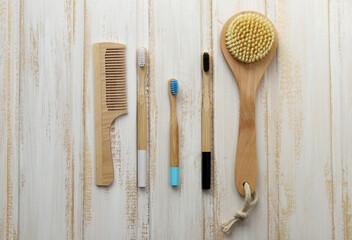 Eco-friendly hygiene and beauty care items for reuse.Wooden toothbrushes, a comb for hair care and a massage brush with natural bristles for skin care. Selective focus. Zero waste.