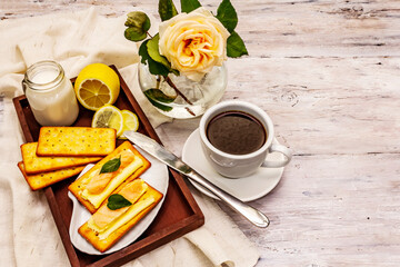 Healthy breakfast. Cup of coffee (black tea), milk, crackers with butter and salmon