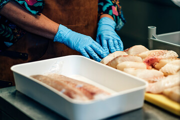 chopped raw fish pieces ready in a restaurant kitchen