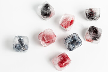 ice cube with raspberry and blueberry