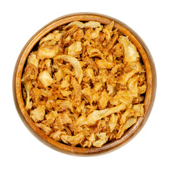 French fried onions in wooden bowl. Crisp deep fried slices of onions, used as garnishes, also in burgers or to garnish biryani. Closeup, from above, on white background, isolated macro food photo.
