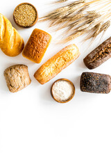 Making bread concept. Loaves near flour, wheat, ears top view copy space