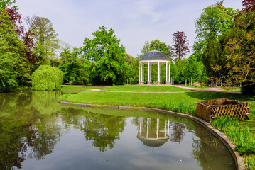 Fototapeta na wymiar Beautiful gazebo with columns in l'orangerie park - city Park in Strasbourg, France