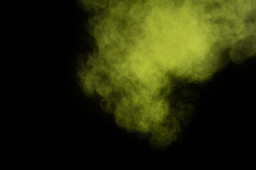 Light green powder explosion on black background. Colored powder cloud. Colorful dust explode. Paint  Holi.
