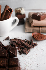 Chocolates with cinnamon and cocoa. On a gray background.