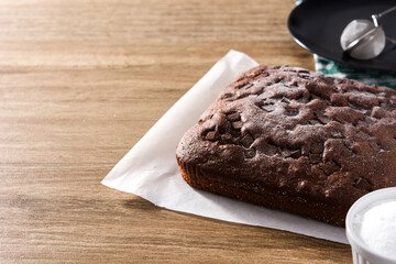Sweet chocolate sponge cake on wooden table. Copy space