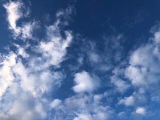Blue sky and white feathery clouds. Copy space and background.