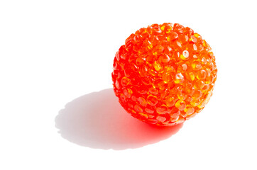 Bright red, orange ball for cats in macro on a white background