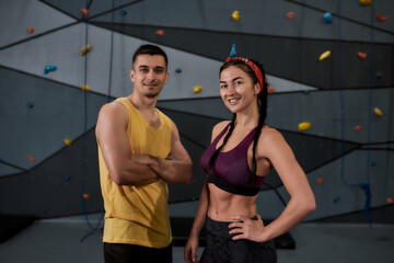 Elevate Your Mood. Active young man and woman in sportswear looking at camera, standing against...