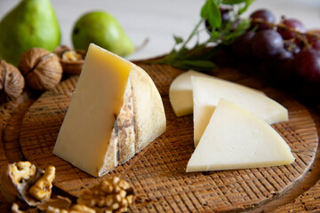 Premium organic goat cheese  on a rustic wooden cheese maker.