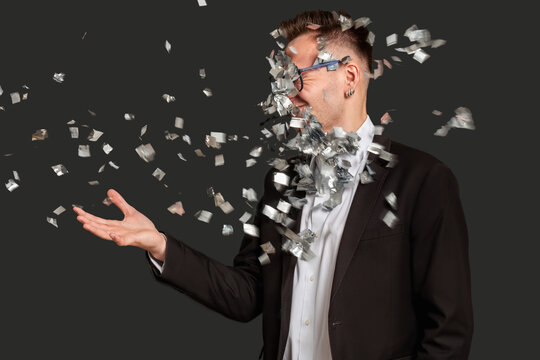 Business trick. Fraud scheme. Fooled man in suit got confetti puff in face isolated on black. Disappointed guy portrait. Professional scam. Silly joke.