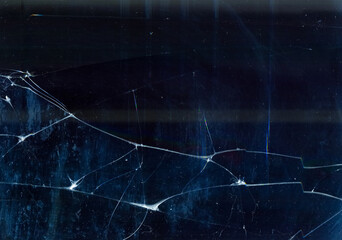 Fractured ice background. Broken glass texture. Blue transparent surface with dust scratches.