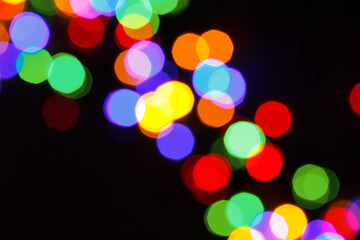 rainbow christmas bokeh lights on a black background