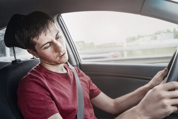 man driving the car fell asleep and does not control the road situation. Drugged with alcohol or insomnia concept. Car crashes and deaths - obrazy, fototapety, plakaty