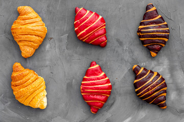 Croissants pattern - set of snacks on dark stone background