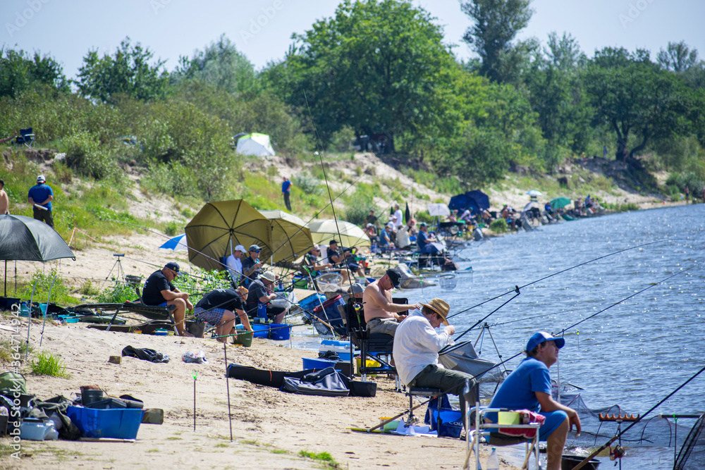 Wall mural feeder fishing competitions on the river close-up.