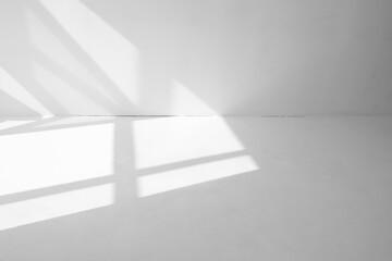 light spots from the window on the white floor and wall