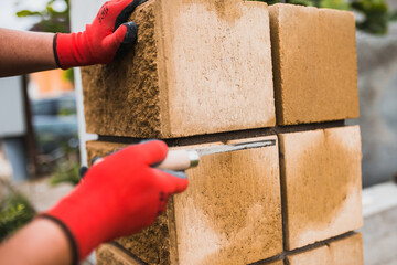 Stonework masons smooth seams between bricks - professional masonry