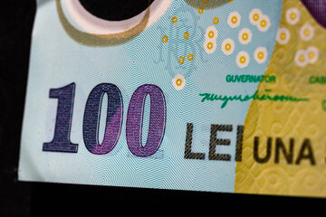 Selective focus on detail of lei banknotes. Close up macro detail of romanian lei banknotes, 100 lei isolated. World money concept, inflation and economy concept