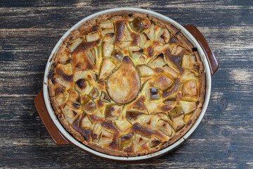 Homemade organic pear pie dessert ready to eat. Pear tart on the old wooden background, close up