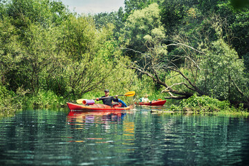 Fototapeta na wymiar Happy best friends having fun on a kayaks. Kayaking on the river.
