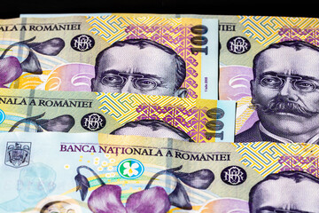 Selective focus on detail of lei banknotes. Close up macro detail of romanian lei banknotes, 100 lei isolated. World money concept, inflation and economy concept