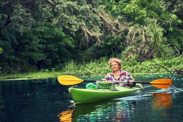 Happy best friends having fun on a kayaks. Kayaking on the river.