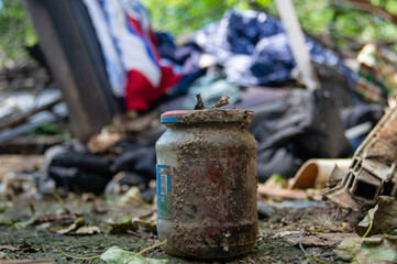 dirty glass jar among the garbage
