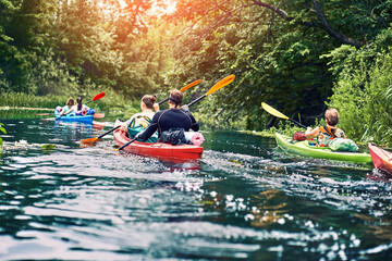 Happy best friends having fun on a kayaks. Kayaking on the river.