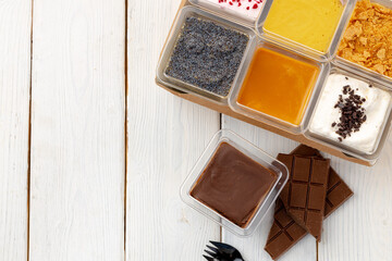 Assortment of delicious dessert boxes on wooden table