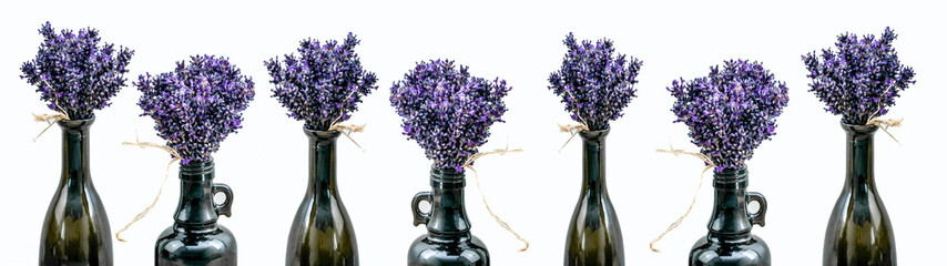 Many bouquet of violet purple lavendula lavender flowers herbs in old brown vases (pharmacy...