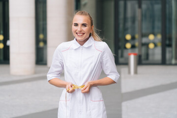 Sad slender girl holds a centimeter tape in her hands. The concept of improper weight loss woman fitness trainer