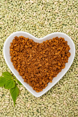 Love vegan and vegetarian food concept, plant based minced meat in heart shaped plate on soya beans background