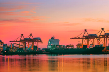 container ship at logistic port against beautiful sunset sky